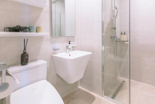 a bathroom with a toilet and a sink and a shower at Le Bleu Naksan by Orot in Yangyang