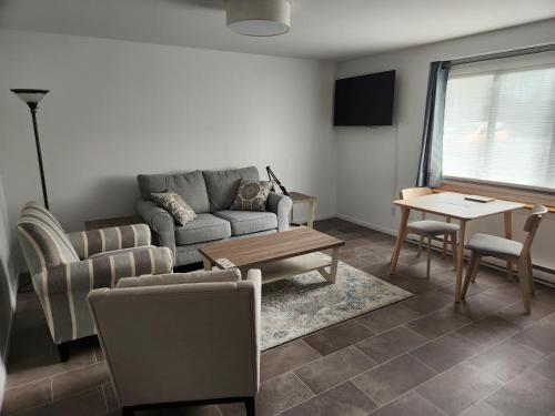 a living room with a couch and a table at D&G Suite Retreat in Sidney
