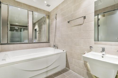 a bathroom with a white tub and a sink at 포항 에이원 호텔 죽도 Pohang A1 Jukdo in Pohang