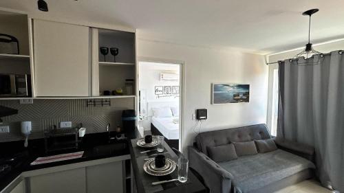 a living room with a couch and a table in a room at Aline Duque - Flat no centro de Porto de Galinhas por Yolo in Porto De Galinhas