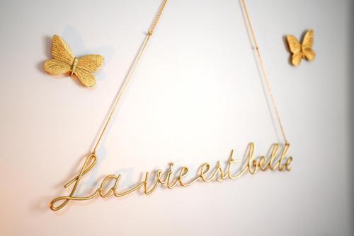 two butterflies on a string with a name necklace at APARTAMENTO ARENA en Playa de San Juan in Alicante