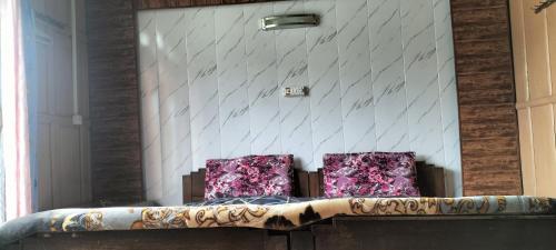 two chairs sitting on a couch in a room at Houseboat Alwar in Srinagar