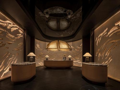 a bathroom with a tub and a chandelier at HUALUXE Shenzhen Bao'an in Shenzhen