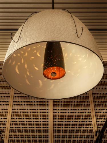 a circular light fixture hanging from a ceiling at HUALUXE Shenzhen Bao'an in Shenzhen