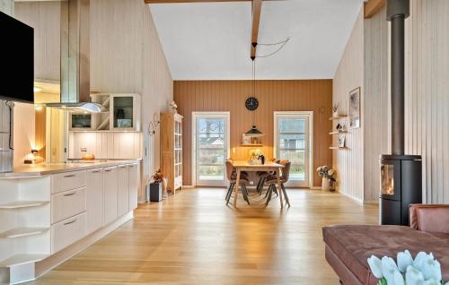 a kitchen with a table and a dining room at Holiday Home Barsbæklund Xi in Loddenhøj