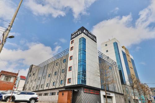 a tall building with a car parked in front of it at 포항 에이원 호텔 죽도 Pohang A1 Jukdo in Pohang