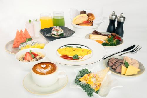 a table with plates of food and a cup of coffee at HUALUXE Shenzhen Bao'an in Shenzhen
