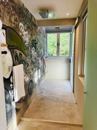 a hallway with a wall covered in graffiti at Villa Mary in Punta Leona