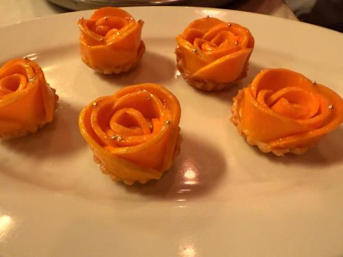 a white plate with six orange pastries on it at Hotel Tulsi Grand inn in Vrindāvan