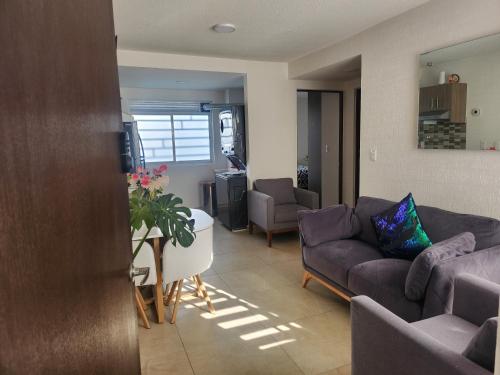 a living room with two couches and a table at Residencial Eduardo Molina in Mexico City