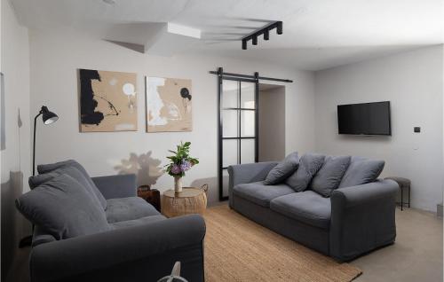a living room with two couches and a flat screen tv at Villa Stanza in Rovinj
