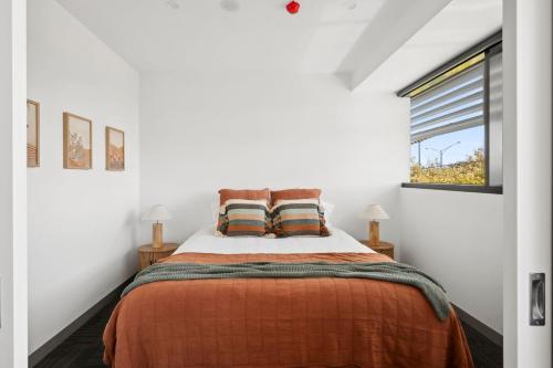 a bedroom with a bed and a window at Lux on Yarra by Regional Escapes in Geelong