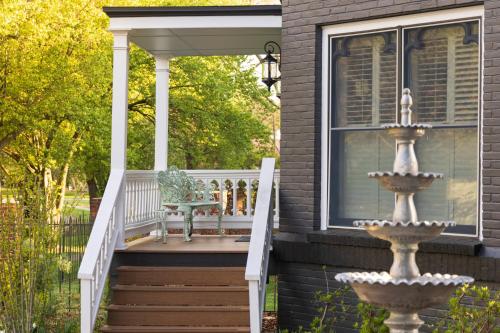 a porch with a fountain on a house at Inn at Woodhaven-In the Heart of the Bourbon Trail-Over 12 Distilleries Nearby in Louisville