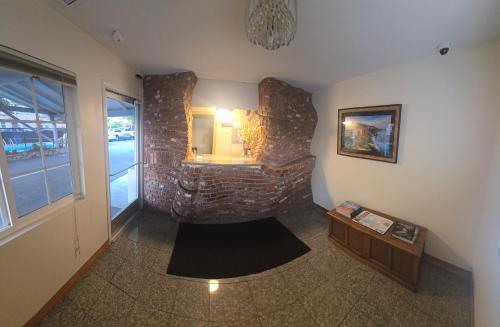 a room with a brick wall with a fireplace at National 9 Motel in Santa Cruz
