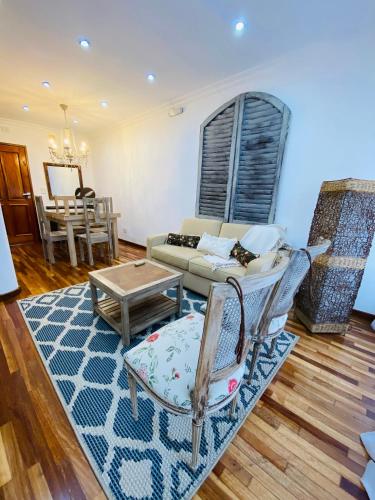 a living room with a couch and a table at THE HEIRS Departamentos in Posadas