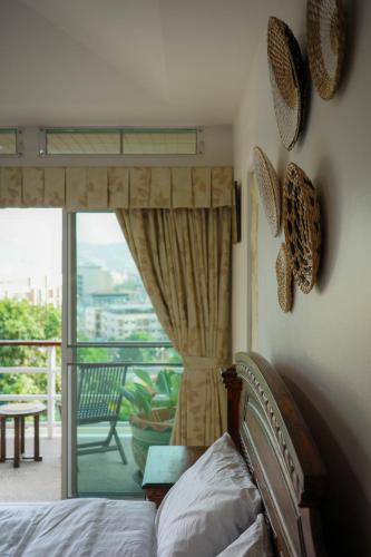 a bedroom with a bed and a view of a balcony at Over the Moon villa in Patong Beach