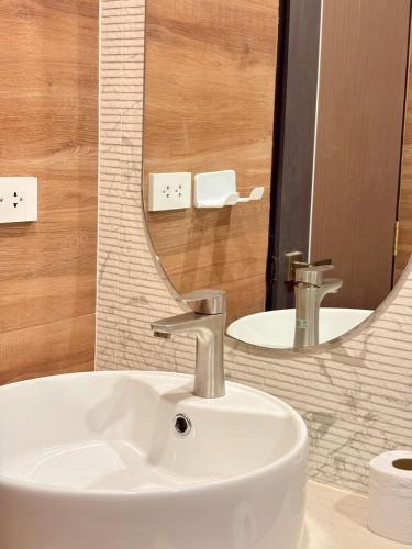 a bathroom with a white sink and a mirror at Medina Private Pool Villa-บางแสน in Ban Puk (1)