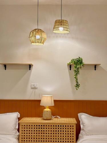 a room with two beds and a table with a lamp at Medina Private Pool Villa-บางแสน in Ban Puk (1)