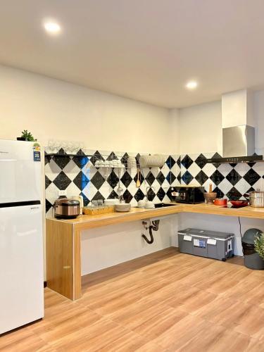a kitchen with a counter and a white refrigerator at Medina Private Pool Villa-บางแสน in Ban Puk (1)