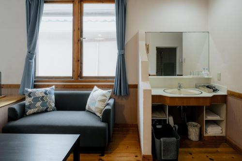 a living room with a couch and a sink at Coast Villa DAISEN in Daisen