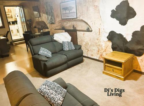 a living room with a couch and a table at Di's Dugouts in Coober Pedy