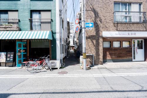 a bike parked on the side of a city street at LN26三宮駅徒歩83LDK貸切和洋戸建サトリハウスa in Kobe