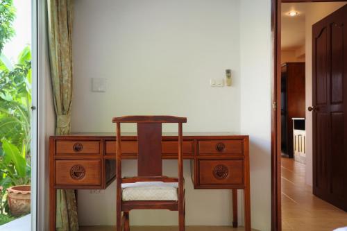 a wooden desk with a chair in a room at Over the Moon villa in Patong Beach
