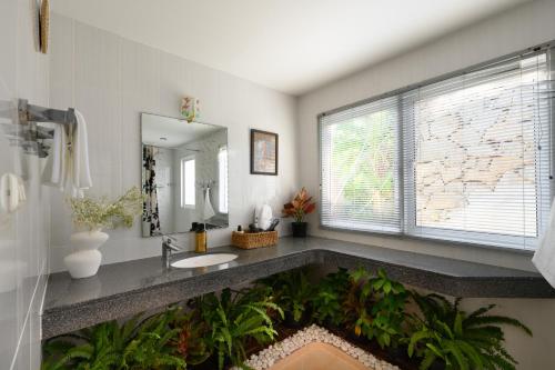 a bathroom with a sink and a large window at Over the Moon villa in Patong Beach