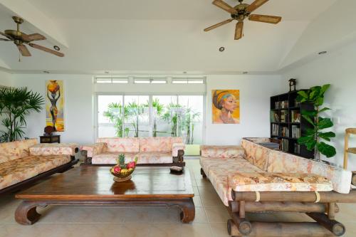 a living room with couches and a coffee table at Over the Moon villa in Patong Beach