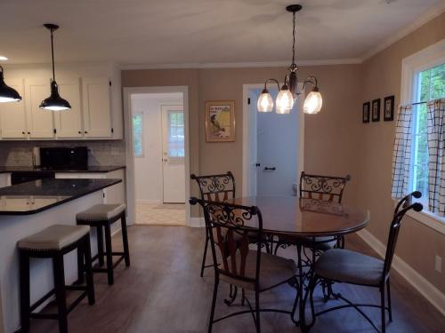eine Küche und ein Esszimmer mit Tisch und Stühlen in der Unterkunft Charming, Cozy Cottage Near Downtown New Bern in New Bern
