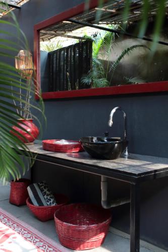 a bathroom counter with a sink and a mirror at Turtle Hill Patnem in Canacona