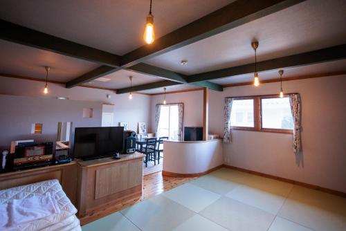 a living room with a flat screen tv and a couch at Coast Villa DAISEN in Daisen