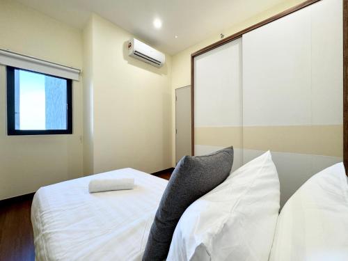 a bedroom with two white beds and a window at Sunsuria Forum SOHO & Residence Suites Setia Alam by MOKA in Shah Alam