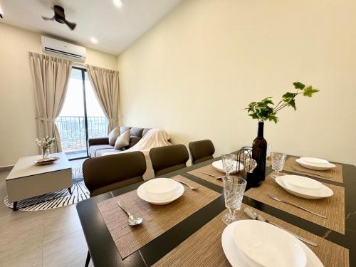 a living room with a dining table and a couch at Sunsuria Forum SOHO & Residence Suites Setia Alam by MOKA in Shah Alam