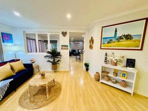 a living room with a couch and a table at Ocean Breeze Family Getaway - Short drive to Beach, Wineries, Kids Golf & Adventure Park in Ocean Grove