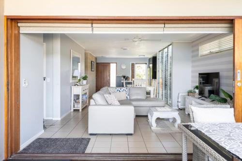 a living room with a couch and a table at Reflections on the lake with resort access in Twin Waters