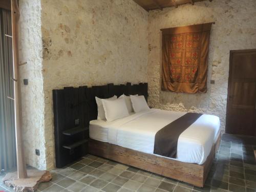 a bedroom with a bed in a room at Imalee - Cottage in Yogyakarta