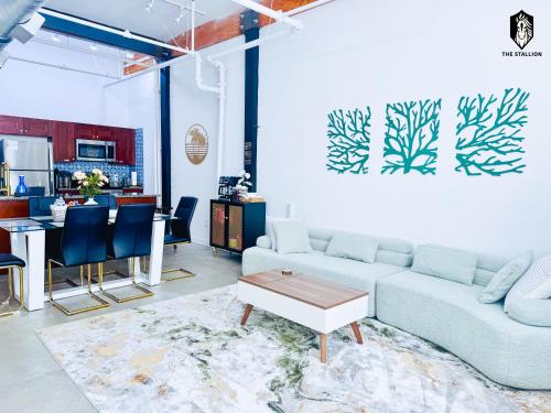 a living room with a couch and a table at The Stallion #108 - Modern Spacious Loft in Downtown with free parking in Memphis