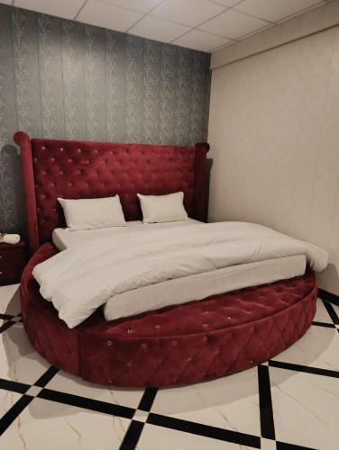 a large bed with a red headboard in a room at Galaxy Hotel Kalam in Kalām