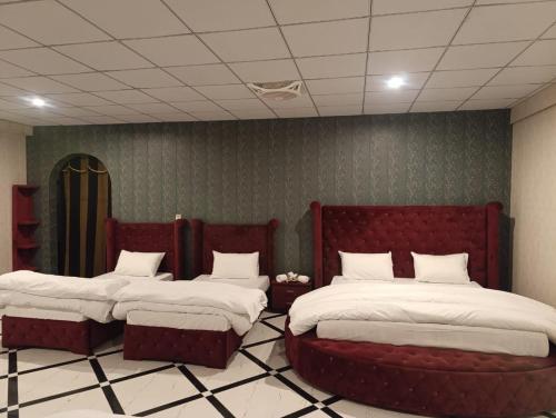 two beds in a room with two bedsskirts at Galaxy Hotel Kalam in Kalām