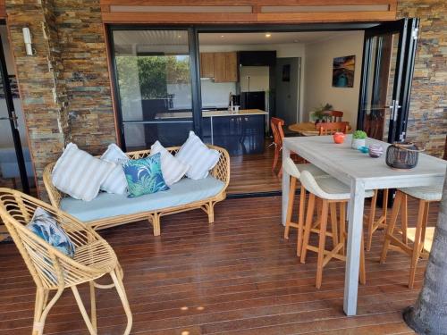 a dining room with a table and chairs at Bermagui Coastal Hideaway - Pet Friendly in Bermagui