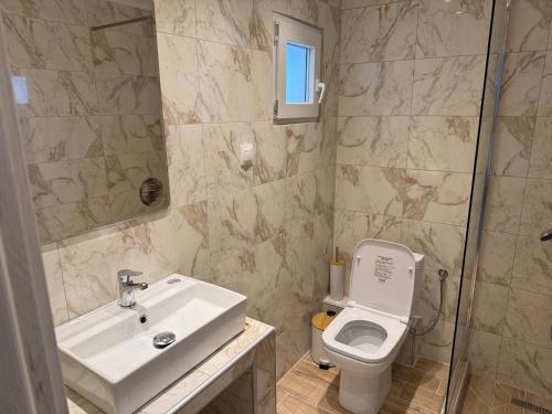 a bathroom with a sink and a toilet at Rooms in center of kallithea in Kallithea Halkidikis