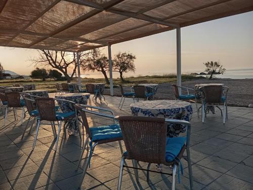 a group of tables and chairs on a patio at Kiotari Coast Seaside in Kiotari
