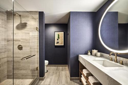 a bathroom with a sink and a shower at Omni PGA Frisco Resort by Suiteness in Frisco