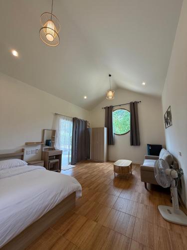 a bedroom with a bed and a desk and a couch at High-In Holiday Home&Villa in Ko Phangan