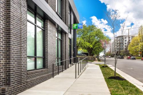 a sidewalk next to a building with a sign on it at Holiday Inn Express & Suites Nashville West End - Univ Area by IHG in Nashville