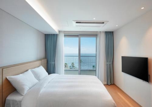 Postel nebo postele na pokoji v ubytování Kumho Jeju Resort