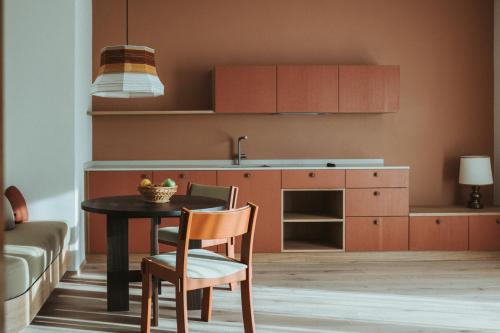 a kitchen with a table and chairs and a sink at Schnitzbichlhof in Lana