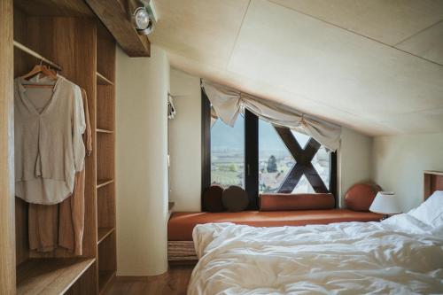 a bedroom with a bed and a window with a view at Schnitzbichlhof in Lana