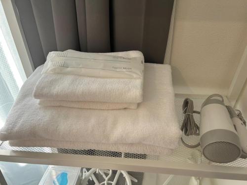 a group of towels are sitting on a shelf at SABBATH uzumaza 103 in Kyoto